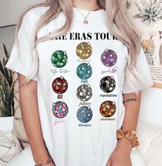 a woman wearing a white t - shirt with the words eras too on it