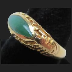 Offering for your consideration is this lovely vintage Chinese jadeite ring. Made of wonderful rich 22K gold. Interior is hallmarked 22K as well as the makers mark. Ring has been tested to ensure the metals purity. It is a size 6 1/4 and has a combined total weight of 4.8 grams. The sides have a Shou symbol which means longevity. Along the top is flowing vines and leaves. It proudly showcases a rich colored piece of Jadeite jade. It is natural A grade and free of any treatments. The eye shaped s Antique Gold Emerald Cabochon Ring, Collectible Gold Emerald Gemstone Ring, Collectible Gold Emerald Ring With Gemstone, Gold Emerald Ring Collectible, Vintage Gold Emerald Cabochon Ring, Vintage Gold Emerald Ring For Collectors, Formal Gold Jade Rings, Heirloom Gold Jade Ring, Heirloom Yellow Gold Jade Rings