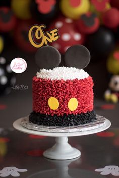 a mickey mouse cake with red and black frosting