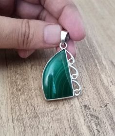 This beautiful pendant features a natural green malachite stone in a fancy shape, set in 925 sterling silver. The charm style locket is handmade with a bezel setting, and is perfect for any occasion including engagement, Christmas, anniversary, Father's Day, birthday, or christening. The pendant has a unique antique and vintage look, with eye clean gemstone clarity grade and a natural creation of the main stone. It is a perfect gift for anyone who loves beauty and African culture. The pendant comes from India and is a one-of-a-kind piece. Gemstone :- Natural Green Malachite  Pendent Weight :- 15.58 Gram  Stone Shape :- Fancy Shape  Metal & Metal Purity :- 925 Solid Sterling Silver We accept custom and personalized order. It can be change in the gemstone, pendant design and pendant size. Pl Green Polished Sterling Silver Gemstones, Green Sterling Silver Gemstones With Polished Finish, Green Sterling Silver Pendant Jewelry, Malachite Pendant Jewelry As A Gift, Green Sterling Silver Jewelry With Polished Finish, Green Sterling Silver Pendant Gemstone, Green Malachite Cabochon Jewelry, Hallmarked Green Pendant Gemstones, Green Spiritual Jewelry With Polished Finish