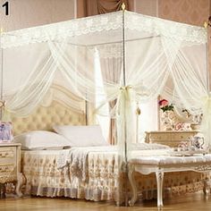 a white canopy bed sitting on top of a hard wood floor next to a dresser