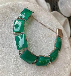 Art Deco Green Chrysoprase Sterling Siliver Vintage Antique Bracelet The bracelet measures 7 inches long See matching necklace in link below https://www.etsy.com/listing/897112044/art-deco-green-chrysoprase-sterling?ref=shop_home_active_1&frs=1 Antique Green Handmade Bracelet, Handmade Antique Green Bracelet, Adjustable Vintage Jade Bracelets, Green Rectangular Bracelet For Formal Occasions, Rectangular Green Bracelets As Gifts, Green Rectangular Bracelets For Formal Occasions, Green Rectangular Bracelets As Gifts, Formal Green Rectangular Bracelets, Vintage Green Rectangular Jewelry