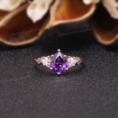 Amethyst Engagement Ring Unique Triangle Cut Moissanite Cluster Wedding Ring Art Deco Pear Shaped Purple Gemstone Rose Gold Bridal Ring RING DESCRIPTION ✦Engagement Ring ✴Center Stone - Amethyst Shape - Pear Cut Size - 6x8mm ✴Side Stones - Moissanite & Alexnadrite Shape - Triangle & Round Cut Weight - 0.26ct ✴Band Width - About 1.5mm ✴Ring Metal: Available in rose gold plated, yellow gold plated, 925 sterling silver, 10k or 14k solid rose, yellow or white gold. MAKING & SHIPPING ✦PAYMENT PLAN ♡ Amethyst Crystal Ring For Wedding In Fine Jewelry Style, Amethyst Crystal Ring For Wedding, Fine Jewelry, Amethyst Crystal Ring For Wedding, Amethyst Diamond Ring With Round Cut For Wedding, Amethyst Diamond Ring With Center Stone For Wedding, Fine Jewelry Solitaire Amethyst Ring For Wedding, Marquise Amethyst Wedding Ring With Center Stone, Marquise Amethyst Ring With Accent Stones For Wedding, Trillion Cut Diamond Ring With Accent Stones For Wedding