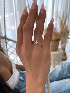 a woman's hand with a diamond ring on it