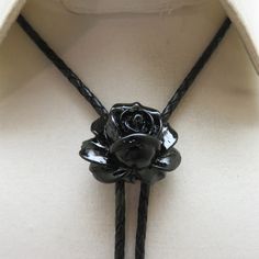 Vintage Black Resin Rose Flower Bolo Tie - Etsy Vintage Formal Bolo Tie Lariat, Vintage Adjustable Bolo Tie For Formal Occasions, Elegant Adjustable Bolo Tie As A Gift, Adjustable Black Flower Jewelry, Vintage Black Lariat Jewelry, Vintage Black Jewelry With Adjustable Length, Vintage Black Bolo Ties For Gift, Vintage Black Bolo Ties As Gift, Black Adjustable Bolo Tie For Formal Occasions