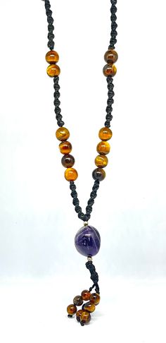 Namaste🙏❤️🙏 This Nacklace is made with genuine real (tiger eye,s ,amethyst) gemstone and black polyester threads using my skills to put love into it. macrame is an art to make boho jewellery. We used in this 27 beads of tiger eye gemstone approx 9mm, A tumble of amethyst gemstone approx 16mm and 9 beads of tiger eye gemstone approx 6mm. TIGER EYE:- Tiger Eye attracts good luck and prosperity, particularly suitable for men and women born under the zodiac signs of Capricorn and Leo. It amplifies their positive qualities and helps minimize the negative traits associated with these signs. It boosts self-confidence and assertiveness, making it beneficial for individuals seeking personal growth and development. Tiger Eye balances energy centers, it is associated with the solar plexus chakra, w Amber Beaded Necklace For Meditation, Handmade Amber Crystal Necklace For Meditation, Amber Bead Necklace 8mm As Gift, Handmade Spiritual Amber Beads, Gems, And Cabochons, Amber Necklaces With 8mm Beads For Gift, Adjustable Amethyst Crystal Necklace For Meditation, Amber Necklace With 8mm Beads For Gift, Handmade Purple Spiritual Beaded Necklaces, Handmade Purple Beaded Necklaces With Spiritual Style