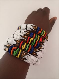 Bracelets | Custom Bracelets | Mother's Gift | Gift Idea | Bangles | Unique Gift | Bracelets For Women | Yoga Bracelets | Daughters Gift These superbly crafted Zulu beaded bracelets are made of fine beads which can be worn in any occasion. Available in different colors.    The price is for 1 piece/bracelet.   For more beaded bracelets ,please click below link: https://www.etsy.com/shop/NanacraftsKE?ref=shop-header-name&listing_id=775922675&from_page=listing&section_id=23600491 Feel free to send White Beaded Bangle With Round Beads, Adjustable Beaded White Bangle, Adjustable White Beaded Bangle, White Bangle Friendship Bracelets With Colorful Beads, White Handmade Round Beads Wristband, Handmade White Wristband With Round Beads, White Handmade Wristband With Round Beads, White Beaded Braided Bracelets, White Beaded Braided Bangle Bracelet