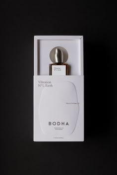 a bottle of booha in a white box on a black background with the lid open