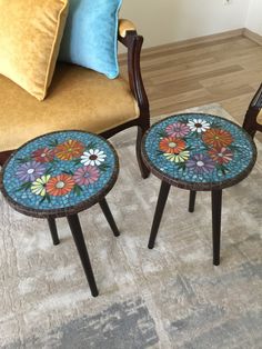 two small tables with colorful flowers on them