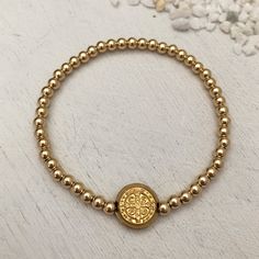 This classic piece is a jewelry lover's must have! Sure to become your new favorite everyday staple. 3mm quality gold fill beads strung on super strong stretch cord. 11mm double sided St Benedict coin charm. Perfect for creating layered looks or wear one alone. Dating back over 1,000 years, the Benedictine cross is one of the most powerful symbols of divine protection in the Christian world. Carry this cross with you at all times as a symbol of protection over you, your loved ones and all of you Adjustable Gold Stretch Bracelet For Everyday, Adjustable Gold Rosary Bracelet, Classic Adjustable Gold Charm Bracelet, Gold Single Strand Spiritual Bracelet, Adjustable Gold Stretch Bracelet Nickel Free, Adjustable Gold Stretch Bracelet Nickel-free, Classic Adjustable Beaded Bracelets, Nickel Free, Adjustable Gold Stretch Bracelet, Nickel Free, Gold Spiritual Charm Bracelet For Everyday