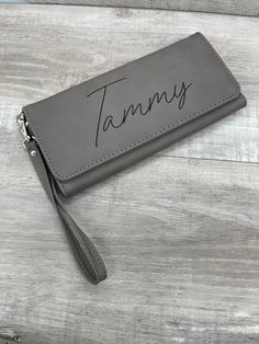 These women's wallets are made from a high quality leatherette and laser engraved (no vinyl stickers or decals here!). It has room for 13 cards (including ID), large open compartment at the back, and a zipping compartment. It snaps shut, and includes a wrist strap. They are just over 7.5 inches wide and 4 inches tall when closed. Since we do our own engraving, we are able to offer a lot of flexibility on what's engraved. We can even add dates if desired (great idea for Bridesmaids' Gifts). Just Wallet With Strap, Wedding Bags, Women's Wallets, Military Gifts, Christmas Gift For Dad, Accessories Bags Purses, Wedding Bag, Gift For Girlfriend, Gift For Wife