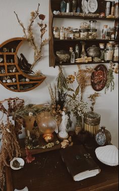 there are many items on the table in this room, including books and vases