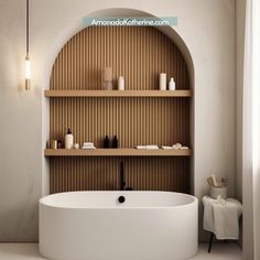 a white bath tub sitting next to a wooden shelf