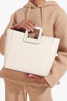 The Shirley Bag is back in solid leather. Includes a removable inner zip pouch and adjustable leather shoulder strap. Chic Square Bucket Bag For On-the-go, Chic Square Satchel For On-the-go, Beige Calf Leather Bag With Adjustable Strap, Chic Beige Calf Leather Shoulder Bag, Square Bag With Detachable Handle For On-the-go, On-the-go Square Shoulder Bag With Detachable Handle, Chic Calf Leather Shoulder Bag With Detachable Handle, Leather Box Bag With Detachable Handle For Everyday Use, Square Bags With Detachable Handle