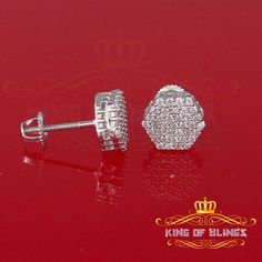 KING OF BLINGS Custom Label :19056W-A16KOB Item Description Step into a world of King Of Blings dazzling elegance and allure with our exclusive collection of Hexagon Cubic Zirconia stud earrings featuring secure screw backs. Indulge yourself or surprise a loved one with these exquisite earrings crafted from premium 925 sterling silver with metal weight 1.92gm and CZ weight of 0.74ct, boasting a lustrous White metal color that exudes sophistication. The real show-stoppers, however, are the meticulously chosen AAA Grade and 'D' Color Cubic Zircon stones. Radiating luxury and brilliance, these stones are carefully graded for clarity and color, ensuring a mesmerizing sparkle that rivals even the most precious diamonds. As a symbolic gesture, these unisex Hexagon earrings represent April's birt Silver Octagon Diamond Earrings, Silver Diamond Octagon Earrings, Silver Octagon Earrings With Diamond Accents, Diamond White Octagon Cubic Zirconia Jewelry, Sterling Silver Octagon Earrings With Prong Setting, White Gold Cubic Zirconia Octagon Earrings, Hexagon Earrings, Hip Hop Bling, Bling Earrings