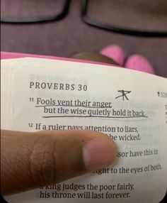 someone is reading a book with their finger on the open page that reads provers 30 fools veintherer anger, but the wise quietly hold it back