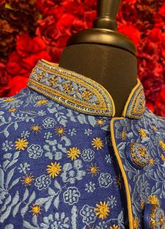 A regal blue sherwani adorned with intricate floral embroidery in gold and silver tones. The high-collared design and detailed buttons exude sophistication, making it perfect for weddings and grand celebrations. The luxurious fabric and rich embroidery make this sherwani a statement piece for any groom or special occasion. Key Features: Color: Royal blue with gold and silver floral embroidery. Design: High-collared with ornate buttons. Fabric: Rich, textured fabric for a luxurious feel. Occasion Royal Kurta For Eid Wedding, Royal Wedding Kurta With Zari Work, Royal Kurta For Wedding And Eid, Designer Blue Kurta With Intricate Embroidery, Royal Wedding Kurta For Eid, Royal Blue Traditional Wear For Formal Occasion, Royal Blue Traditional Wear For Formal Events, Designer Blue Formal Sets, Royal Festive Wedding Kurta