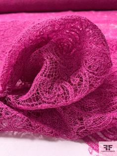 a close up of a pink scarf on a white surface