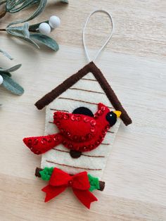 a birdhouse ornament hanging on a wooden table