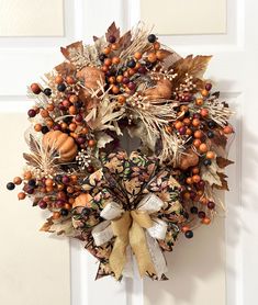 an autumn wreath hanging on the front door