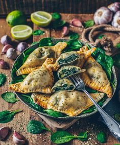 spinach and cheese stuffed ravioli in a bowl with a fork on the side