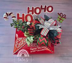 a bag filled with candy and decorations sitting on top of a wooden table next to the words ho hoo