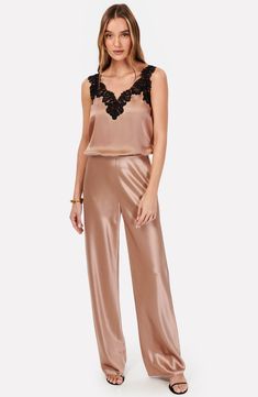 Fall for the sleek silhouette of these night-out pants designed with a high waist and crafted from glossy satin. 31" inseam; 21 1/2" leg opening; 11 1/2" front rise (size Small) Unlined 73% acetate, 27% polyester Dry clean Imported Elegant Satin Pants For Loungewear, Elegant Silk Bottoms For Date Night, Chic Bottoms With Satin Finish For Party, Chic Silk Pants For Night Out, Chic Satin Finish Bottoms For Party, Chic Party Bottoms With Satin Finish, Glamorous Satin Pants For Formal Occasions, Sleek Satin Pants For Evening, Glamorous Satin Bottoms For Evening