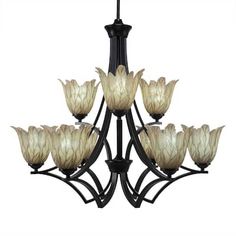 a black chandelier with white flowers hanging from it's center and six lights on each side