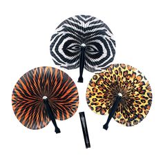 three decorative hand fans with animal print designs on the sides and black handles, all in different colors