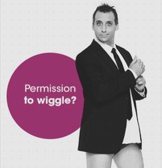 a man in a suit and tie standing with his arms crossed, which says permision to wiggle?