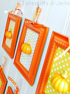 three orange frames hanging on the wall with pumpkins and polka dotes around them