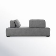 a gray couch sitting on top of a white floor