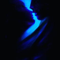 the silhouette of a man and woman in blue light