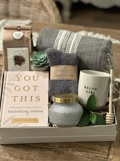 the gift box is filled with candles, towels and other personal care items for someone's special occasion