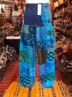 Our harem pants are one size the scrunch top Allows these pants to comfortably fit a range of sizes these pants can fit small to xxl  Measurements  Waist 24-44. Inches  The scrunch waist allows these pants to ft a range of sizes Length 39 inches  From top of pants to bottom  Inseam 27 inches Bohemian Harem Pants With Pockets For Vacation, Harem Pants With Pockets For Beach, Blue Hippie Harem Pants With Pockets, Bohemian Patchwork Harem Pants, Beach Baggy Harem Pants With Elastic Waistband, Baggy Harem Pants With Elastic Waistband For Beach, Hippie Harem Bottoms For The Beach, Hippie Harem Pants For Beach, Multicolor Harem Pants For Beach