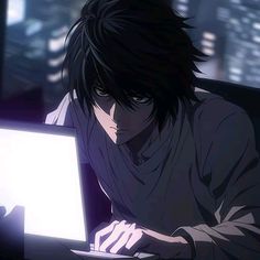 a man sitting in front of a laptop computer