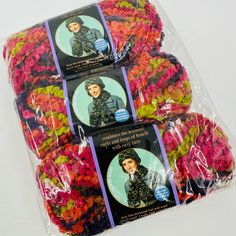 three bags of crochet yarn in different colors