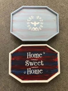 two signs that say home, sweet home and the words above them are painted on wood