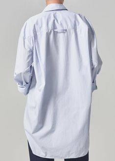 Known for our timeless wovens, we introduce our newest best-seller - the Cocoon Shirt. This oversized silhouette is perfect for pairing back to a sleek skinny or classic cargo. This fit is true to size. Looks Like: Baby sky blue Feels Like: Breathable, ultra-lightweight cotton From our HUMANITY Collection Oversized Tops With Roll-up Sleeves For Everyday, Oversized Top With Roll-up Sleeves For Everyday, Oversized Effortless Shirt With Shirttail Hem, Classic Oversized Shirt With Cuffed Sleeves, Chic Workwear Tops With Curved Hem, Casual Tops With Concealed Placket And Relaxed Fit, Chic Tops With Curved Hem For Work, Classic Shirt For Layering With Shirttail Hem, Casual Cotton Blouse With Concealed Placket