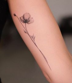 a single flower tattoo on the arm