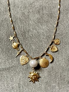 "Sun" necklace features a curated selection of vintage brass charms from the 60s, 70s and 80s from France, Italy, and the United States. Charms are finished with a layer of Renaissance wax, the same finish used by art conservators in British Museum. "Sun" necklace measures 16" - 18" long on an adjustable chain. Vintage Boho Jewelry, Alaska Young, Galaxy Earrings, Sun Charm, Sun Necklace, Moody Wedding, France Italy, Repurposed Vintage, Thrift Finds