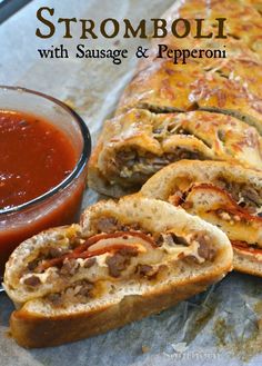 sausage and pepperoni stuffed bread roll with sauce on the side, ready to be eaten