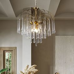 a chandelier hanging from the ceiling in a living room