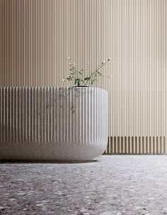 a planter sitting on top of a floor next to a wall