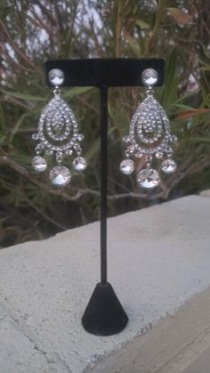 "These fun and stylish rhinestone long chandelier earrings make a statement. Great statement piece! Pageant, prom, or bridal! Size of earrings: 1.5\" wide and 3.5\" Long. Color: Clear Rhinestones Base Metal color: silver Style: Pierced Need a matching bracelet? https://www.etsy.com/listing/767597835/clear-rhinestone-stretch-bracelet?ref=shop_home_active_31 https://www.etsy.com/listing/600792630/clear-rhinestone-bracelet-rhinestone?ref=shop_home_active_67&frs=1 https://www.etsy.com/listing/74 Pageant Earrings, Bridal Statement Earrings, Bridal Earrings Chandelier, Long Chandelier, Bridal Clip, Fun Ornaments, Crystal Chandelier Earrings, Prom Earrings, Rhinestone Bridal