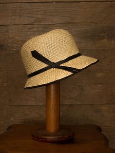 "An authentic antique woven cloche from the late 1920s or 30s era. Originally acquired by a European hat shop that closed in the 1930s. Made from a light colored woven straw with a simple yet elegant black wax coated ribbon and buckle. Only minor signs of age from storage, never been previously used. Centimeter measurements written on the inside of the crown by the hat maker. material : straw, silk? ribbon color : black, light beige condition : little to no wear, has never been used size : pleas Vintage Black Brimmed Sun Hat, Adjustable Wide Brim Flapper Hat, Fitted Flapper Cloche Hat With Brim, Gatsby Style Adjustable Cloche Hat With Curved Brim, Fitted Flapper Cloche Hat With Curved Brim, Kentucky Derby Flapper Hat With Short Brim, Adjustable Gatsby Cloche Hat With Curved Brim, Adjustable Cloche Flapper Hat, Adjustable Cloche Hat In Flapper Style