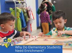 two young boys playing with wooden blocks and magnets on a table in a classroom