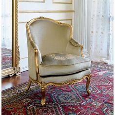 an ornate chair sitting in front of a mirror on top of a carpeted floor