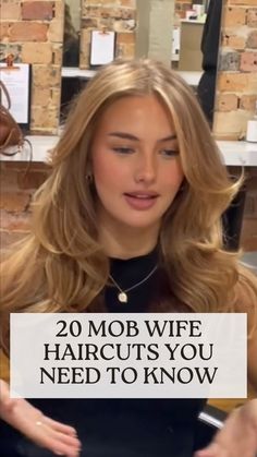 a woman holding a sign that says 20 mob wife haircuts you need to know