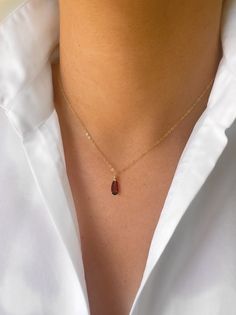 "A deep red garnet tear drop hung from a delicate gold chain. A beautiful gift to show someone you care, or a little bit of self love. Garnet is the birthstone of the January born. The necklace pictured is 16\" though custom lengths are available on request. Available in 9ct gold, gold filled as pictured, rose gold filled and sterling silver. Comes beautifully gift wrapped as pictured. Garnet is a spiritual stone of higher thinking and self-empowerment, it is also a stone of strength and safety. It is a stone of prosperity and abundance, encouraging gratitude and service to others.  Gold filled is made by heat and pressure bonding a layer of karat gold to a metal core. Unlike gold plated, gold filled has an actual layer of karat gold, not just a microscopic film and with the proper care wi Dainty Rose Gold Teardrop Pendant Charm Necklace, Red Gemstone Drop Necklace For Gift, Red Drop Necklace For Gift, Elegant Red Drop Necklace For Gift, Gift Garnet Drop Jewelry, Dainty Teardrop Charm Necklace With Delicate Chain, Red Teardrop Gemstone Drop Necklace, Garnet Drop Jewelry For Gift, Dainty 14k Gold Teardrop Pendant Charm Necklace